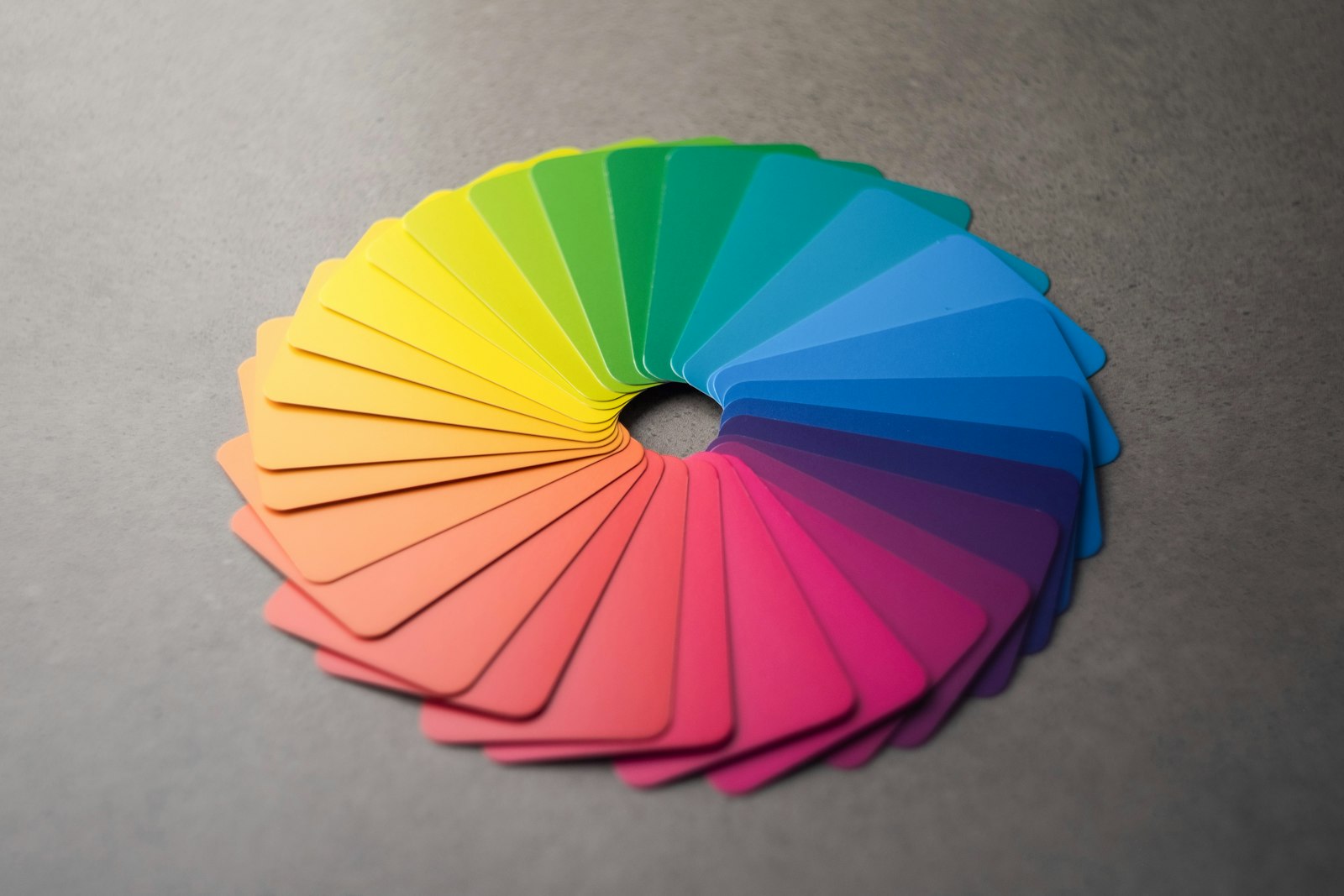 A fan of color sample cards arranged in a full spectrum